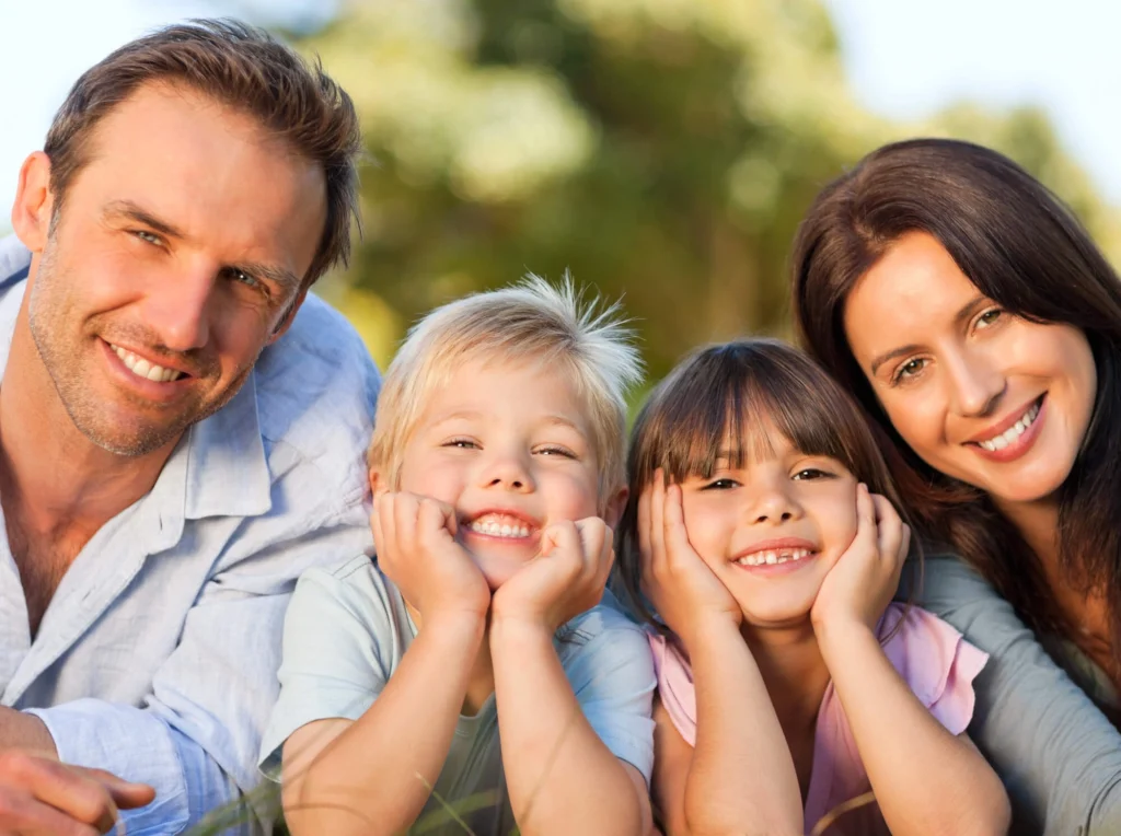 Family smiling after teeth cleaning by Dentist in Harrison NY