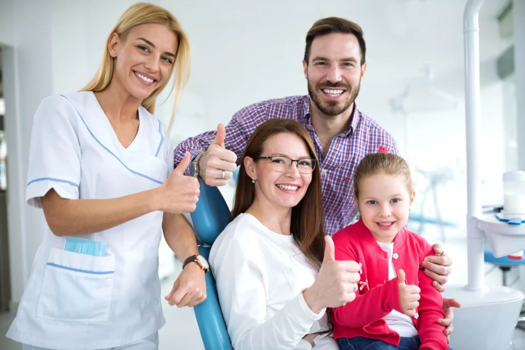 Family smiling with their Dentist in Harrison NY