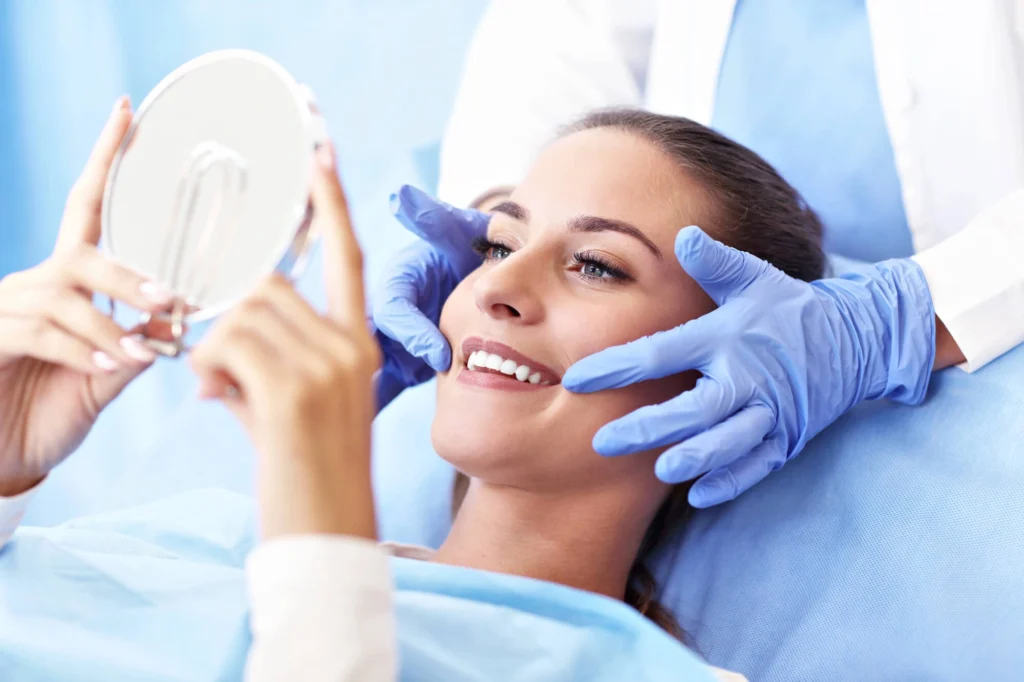 Girl checking her porcelain veneers by a Gentle dentist Westchester NY