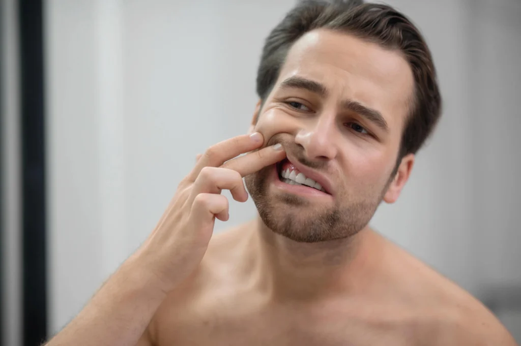 Man experiencing swollen gums needing Gentle Touch Dentistry