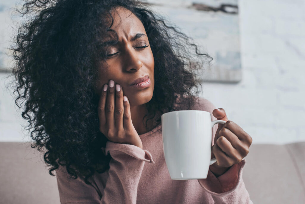 Woman experiencing tooth pain needing a Gentle dentist Harrison NY