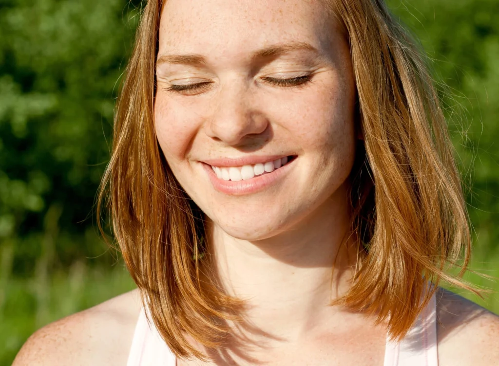 Girl smiling after treatment with a Cosmetic dentist Harrison NY