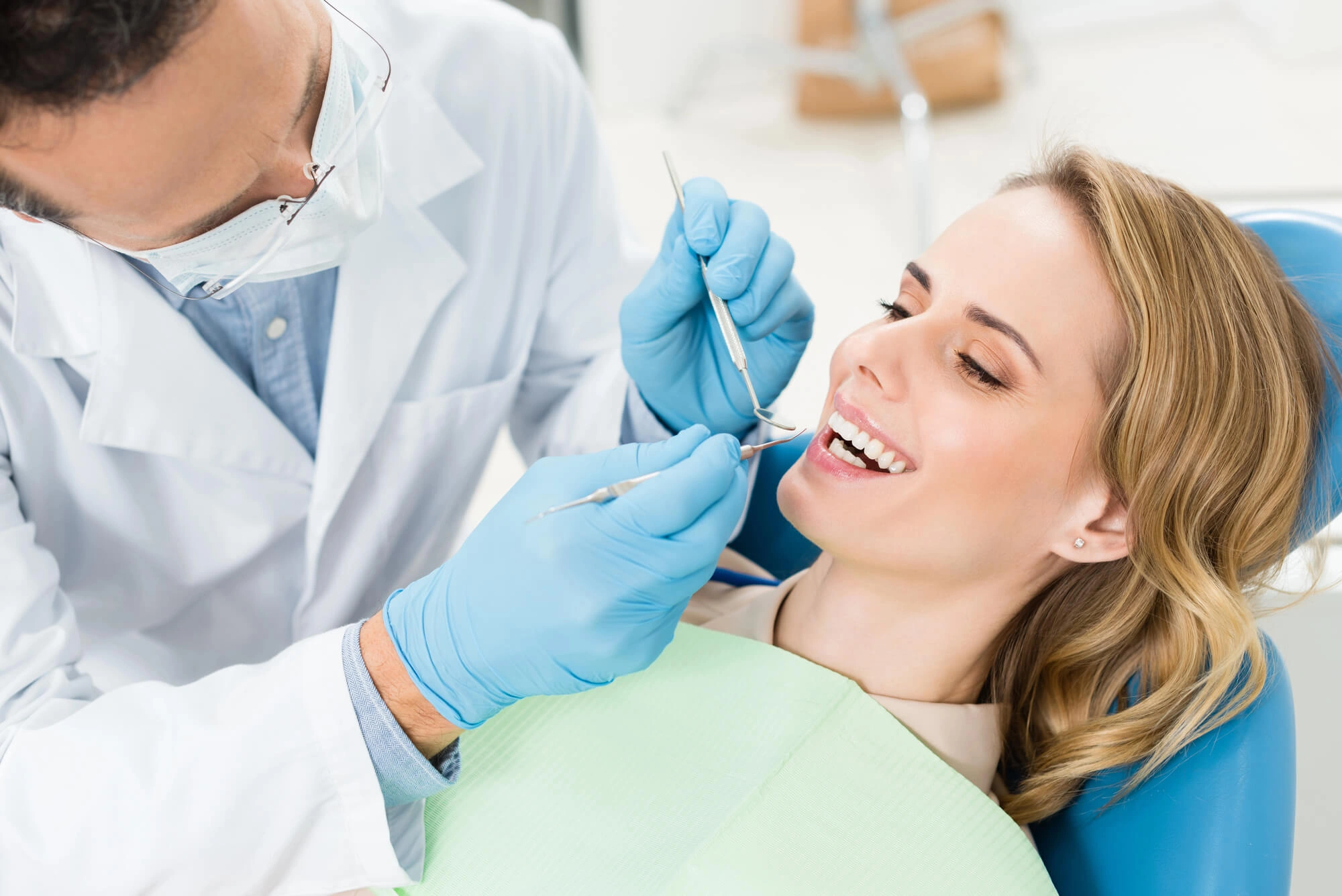 Woman getting her gums checked by Dentist in Harrison NY