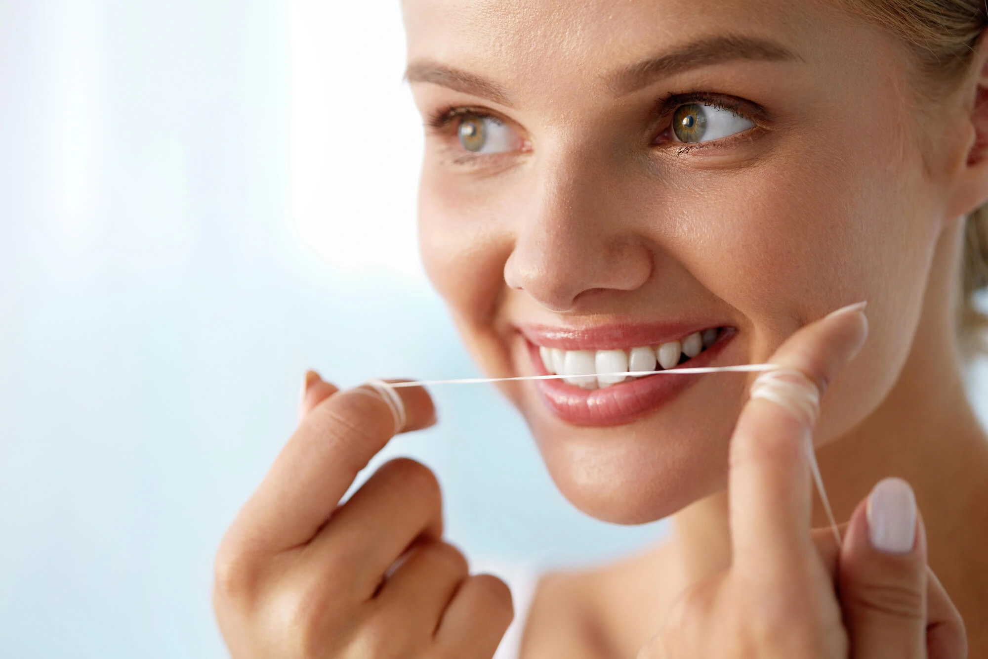 Flossing her Dental implants Mamaroneck NY
